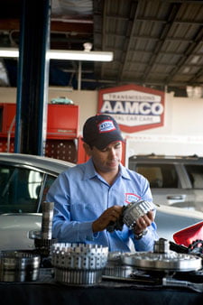AAMCO Mechanic working on a Transmission Image of AAMCO Mechanic working on a Transmission